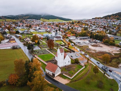 Small town with a central church, nestled in an autumn-colored area, Wehingen, Tuttlingen district,
