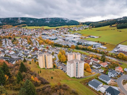 View of village with colorful autumn leaves and dark clouds, Wehingen, Tuttlingen district, Germany