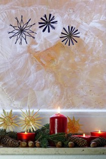Christmassy decorated iced window, candle light, straw stars, Germany