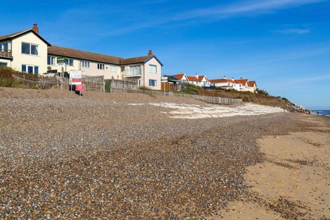 For Sale estate agent signs outside houses at risk of coastal erosion, Thorpeness, Suffolk, North