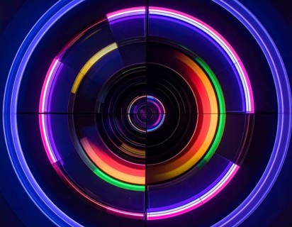 Abstract background of slightly unfocused multicolored glass lenses spinning and rotating,