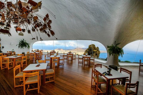 Interior of café with panoramic window in building designed by Cesar Manrique with the