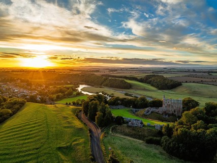 Sunset over Norham Castle and River Tweed from a drone, Norham, Northumberland, England, United