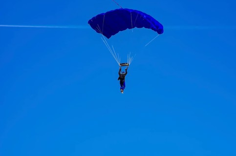 Skydivers during an aerial acrobatic performance as part of an air show at the Fliegerbergfest of