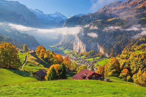 View from the village of the Lauterbrunnen Valley with Staubbach waterfall in autumn with morning