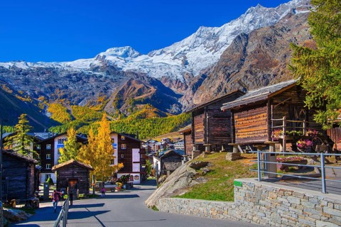 Typical granaries on the outskirts of the village with Alphubel 4206m and Mischabel group 4545m in
