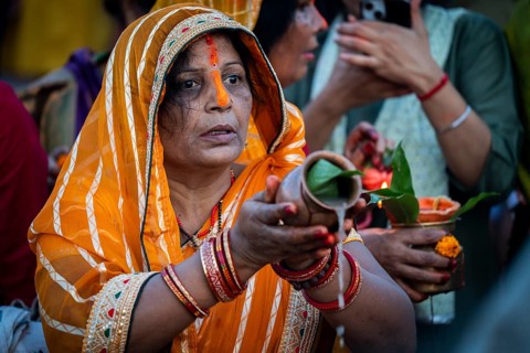 Hindu devotees offer prayers to the Sun God on the bank of Brahmaputra river on the occasion of