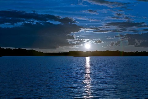 Atmospheric moonrise over Lake Gudelack, Lindow (Mark), Stechlin-Ruppiner Land nature park Park,