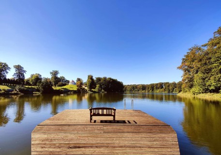 Footbridge with bench to Huwenowsee at Meseberg Castle Park, guest house and conference venue of