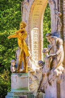 The gilded bronze statue of Johann Strauss, the Waltz King, memorial in the municipal park, Vienna,