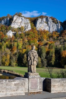 Statue, saint statue of Saint Nepomuk, patron saint of bridges, bridge saint on the historic arched