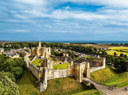 Warkworth Castle over River Coquet from a drone, Warkworth, Northumberland, England, United Kingdom