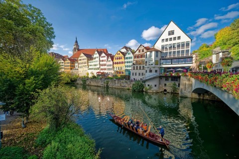 Historic houses on the Neckar front, the Neckar river with poking and water reflection, old town of