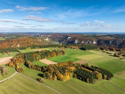 Aerial view of Upper Danube Valley surrounded by autumn vegetation, on the horizon Werenwag Castle,
