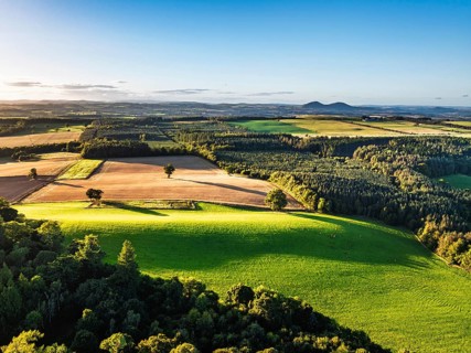 Fields and Farms over River Teviot and Minto Crags from a drone, Roxburghshire, Scottish Borders,