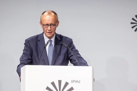Federal Chancellor Friedrich Merz (CDU) . Portrait at the lectern with free text space.