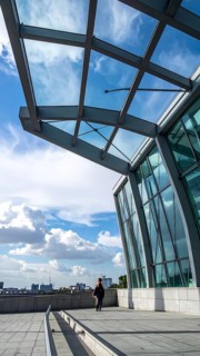 Modern architectural framework with glass and steel structure, glass facade with a greed of steel