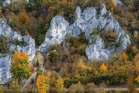 Distinctive Jurassic limestone cliffs in the upper Danube Valley, surrounded by autumn vegetation,