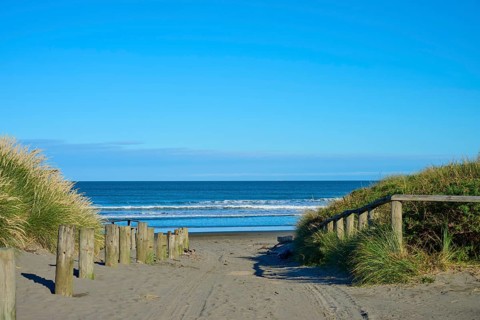 View of quiet beach path with ocean views under clear skies, Spencer Park Beach, Spencerville,