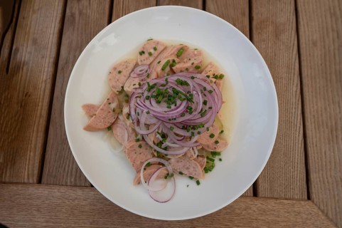 City sausage served with onions in a garden restaurant, Franconia, Bavaria, Germany