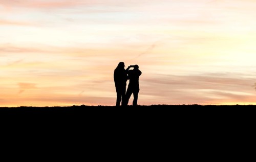 Walkers with mobile phone at sunset on a dike, Fehmarn island, 13.10.2025, Fehmarn,