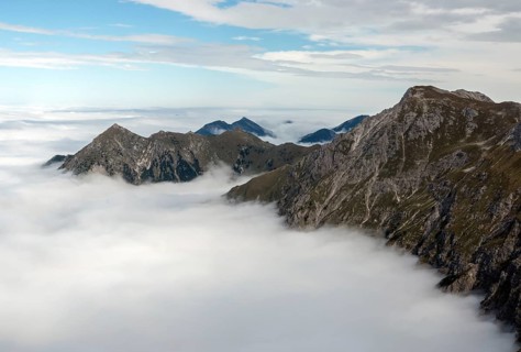 View from the Nebelhorn summit to mountains of the Allgäu Alps, mountains rising from fog in the