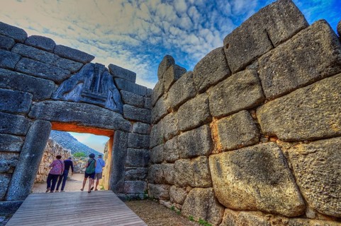 HDR, group of visitors passes through a huge stone gate, lion gate, Mycenae, archaeological site,