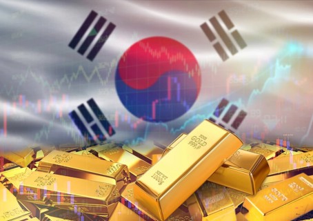 Gold bars on South Korea flag in background. Gold bars stacked on South Korean flag. Concept of