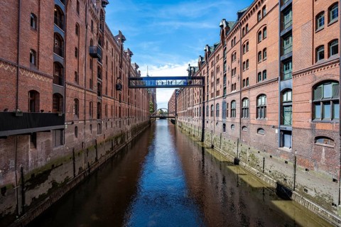 Canal between red brick buildings, warehouses in Hamburg's Speicherstadt, Hamburg, Germany