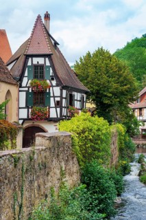 Picturesque Kaysersberg with half-timbered houses on the Weiss river in the old town centre