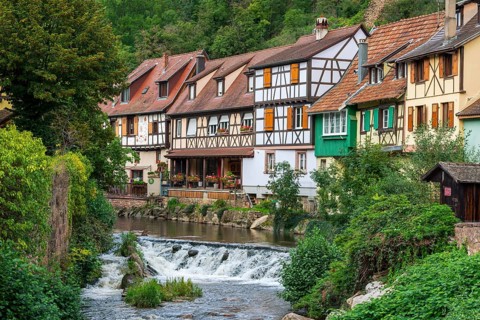Picturesque Kaysersberg with half-timbered houses on the Weiss river in the old town centre