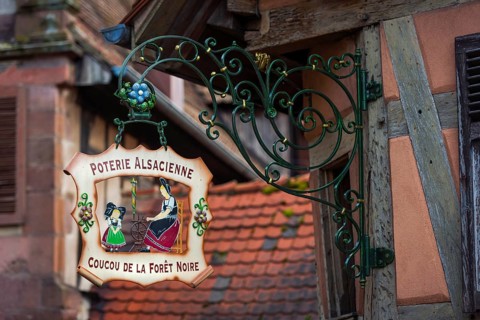 Historic guild sign of a clothing shop in the old town centre of Kaysersberg