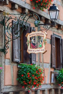 Historic guild sign of a clothing shop in the old town centre of Kaysersberg