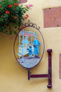 Historic guild sign of an ice cream parlour in the old town of Kaysersberg