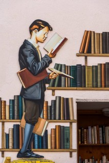 Historical wall relief with young pupil at the library, Ribeauvillè