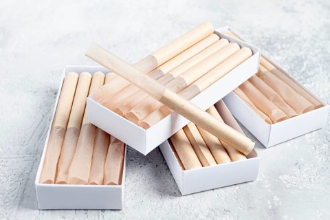 Cigarette casings, packed in boxes, on the table, top view