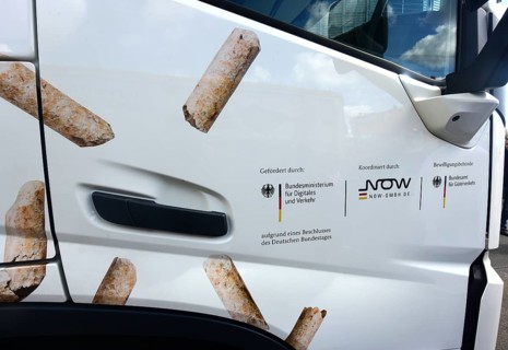 The passenger door of an electric lorry shows which state institutions have paid and approved