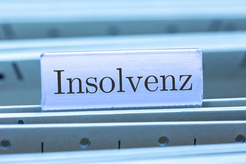 (Photomontage) Sign with the inscription INSOLVENCE on a suspension file folder
