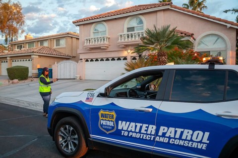 Las Vegas, Nevada - Devyn Choltko, a water waste investigator, patrols a residential neighborhood,