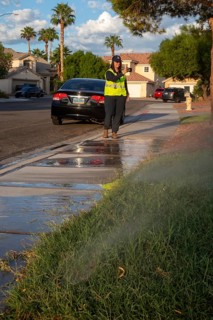 Las Vegas, Nevada - Devyn Choltko, a water waste investigator, patrols a residential neighborhood,