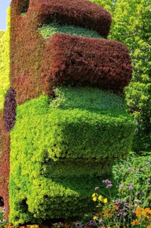 Close-up of Gear sculpture made of live green, maroon and red Alternanthera plants in summer,