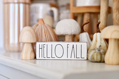 Germany - October 2025: Boho autumn home decor with ceramic pumpkin, wooden mushroom and Hello Fall
