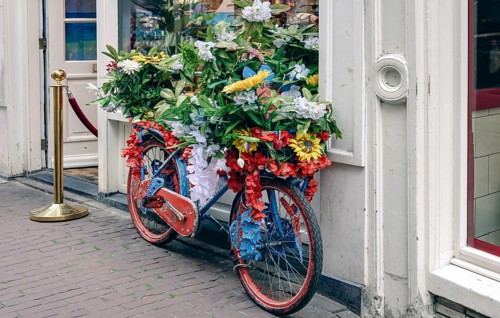 Bicycle on Amsterdam canals with scenic bridges and historic city center, UNESCO World Heritage