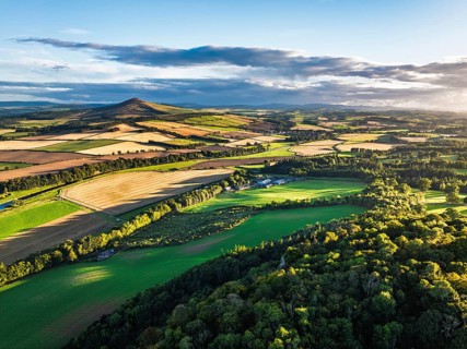 Fields and Farms over River Teviot and Minto Crags from a drone, Roxburghshire, Scottish Borders,