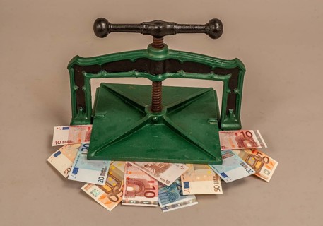Euro banknotes in a press. Symbolic image for currency problems