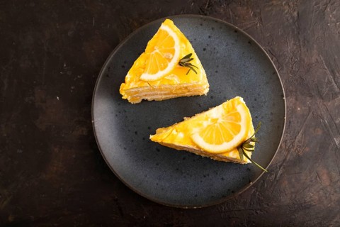 Lemon cake on black concrete background, top view, flat lay, close up