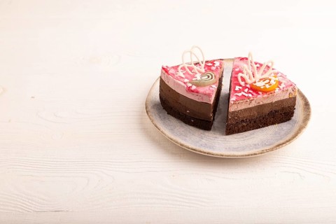 Chocolate cake on white wooden background, side view, copy space