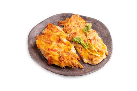 Baked chicken meat with cheese and tomatoes isolated on white background. side view, close up