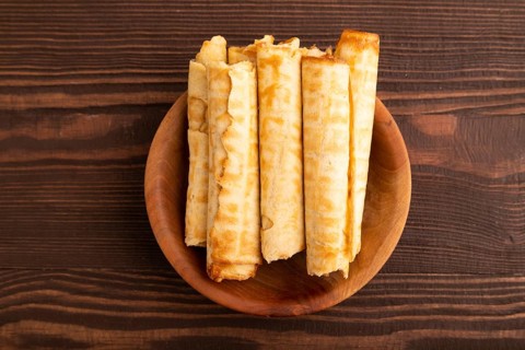 Waffles with caramel on brown wooden background, top view, flat lay, copy space