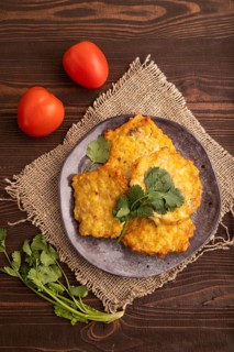 Fried crispy Chicken pancakes on brown wooden background and linen textile. top view, flat lay,